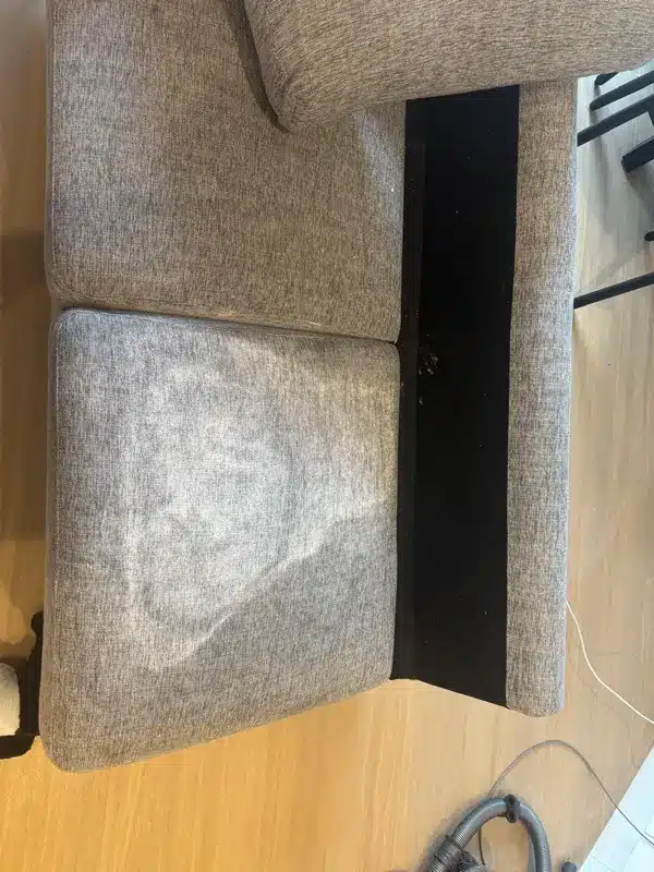 Before grey fabric couch with a stained seat cushion cleaning by Everfresh Cleaning in Melbourne